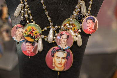 Close-up of necklace with photographs