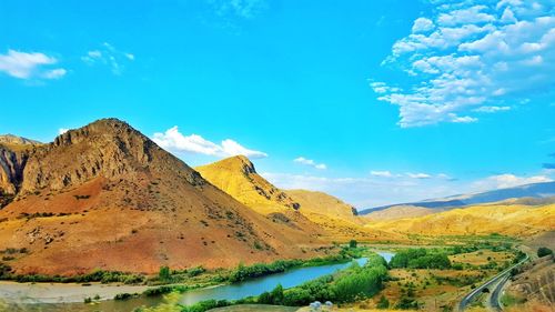Scenic view of landscape against blue sky