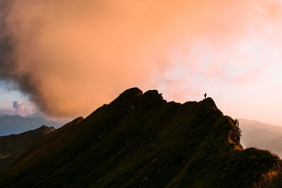 Scenic view of mountains against sky at sunset