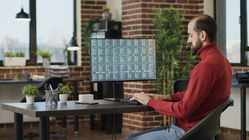 Businessman using desktop pc at office