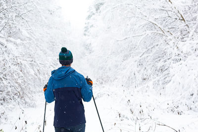 Rear view of man on snowcapped mountain