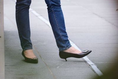 Low section of man standing on footpath