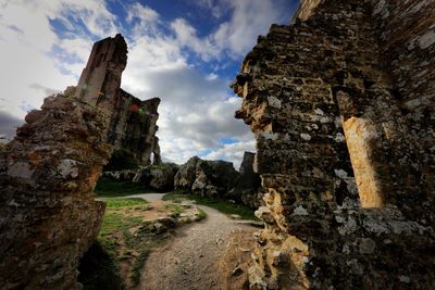 Low angle view of rock formations against sky