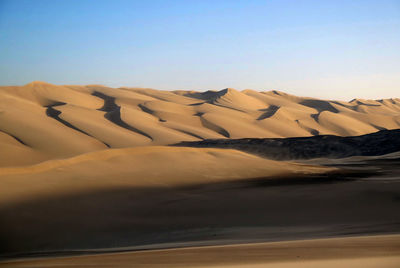 Scenic view of desert against clear sky