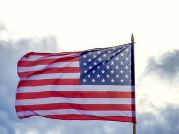 Low angle view of american flag against sky