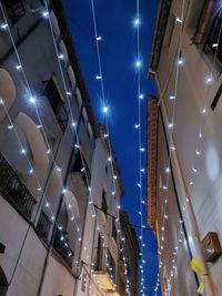 Low angle view of illuminated buildings at night