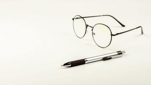 High angle view of pen on paper against white background