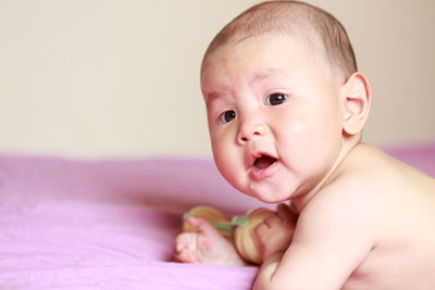 Portrait of cute baby in bed