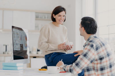 Couple working on desktop pc at home