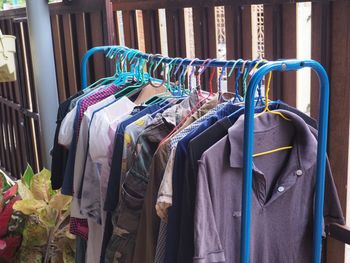 High angle view of clothes hanging on rack by fence