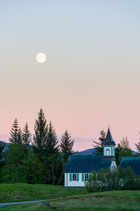 Scenic view of trees and buildings against sky