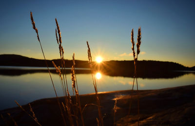 Scenic view of lake against sky during sunset