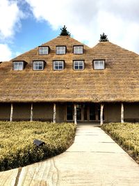 Exterior of house by building against sky