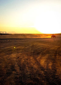 Scenic view of field against clear sky during sunset