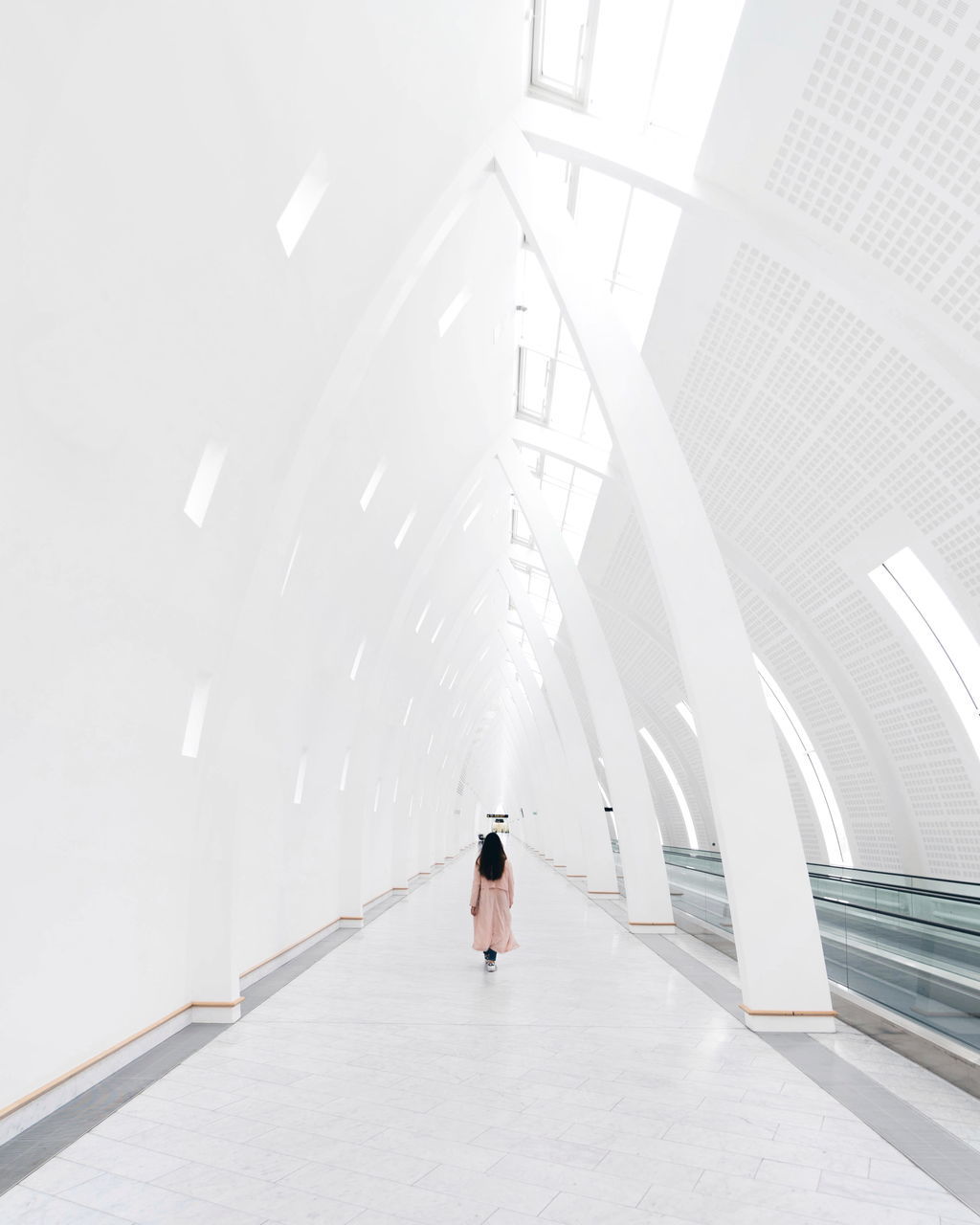 architecture, one person, real people, built structure, indoors, lifestyles, direction, the way forward, full length, rear view, building, railing, day, women, transportation, steps and staircases, ceiling, leisure activity, wall - building feature, modern