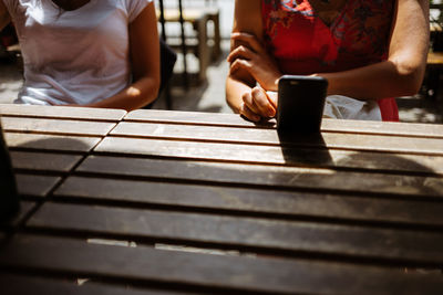 Midsection of women sitting at table