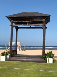 Built structure on beach against clear sky