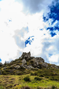 Low angle view of rocks on landscape against sky