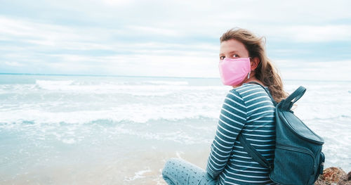 Woman on beach against sky