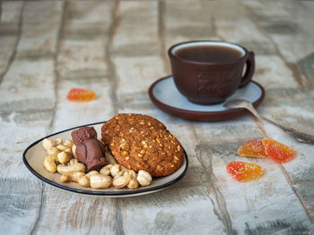 Tea with oatmeal cookies. a large mug in a hand-knitted warmer made