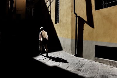 Rear view of man standing on floor