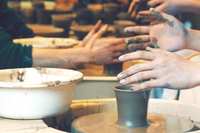 People making a bowl in pottery class