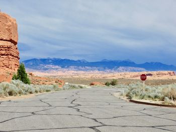 Road by landscape against sky