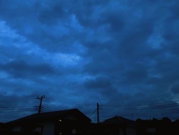 Low angle view of silhouette buildings against sky