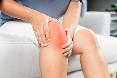 Midsection of woman sitting at home