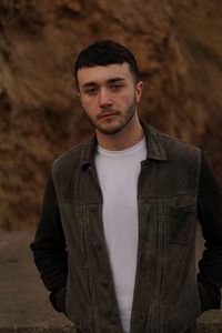 Close-up portrait of young man against wall