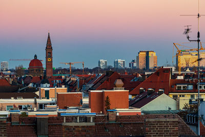 Buildings in city at sunset
