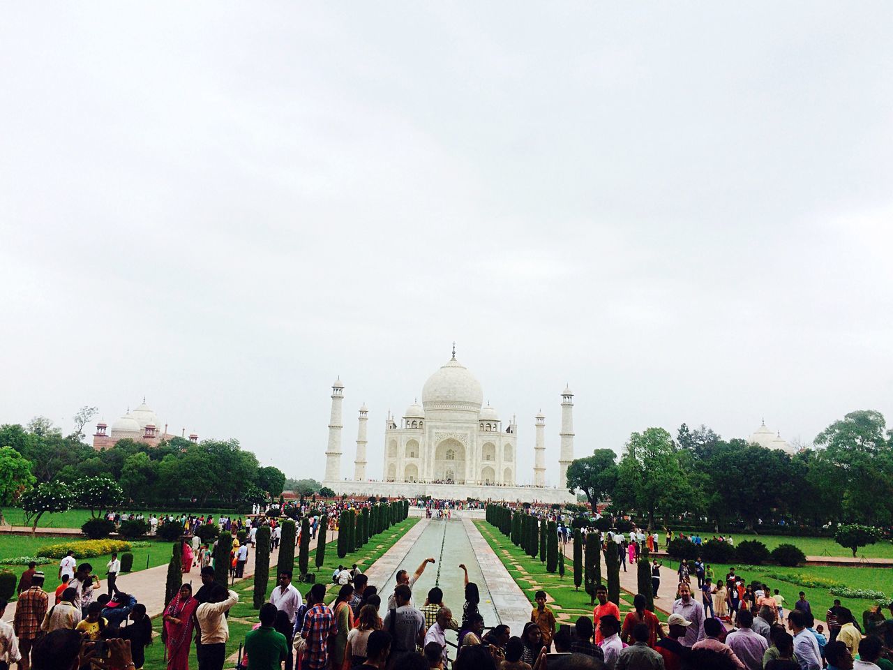 large group of people, famous place, architecture, tourism, religion, international landmark, place of worship, built structure, travel destinations, spirituality, person, travel, building exterior, tourist, men, history, grass, dome