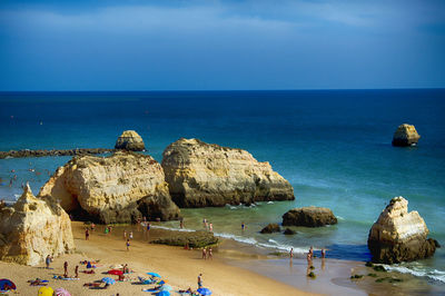 Panoramic view of rocks on beach against sky