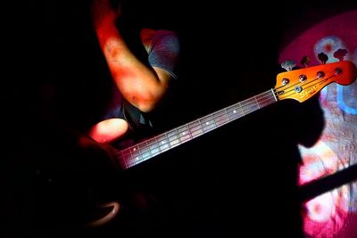 Cropped image of man playing guitar