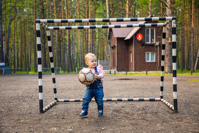 Full length of boy playing in playground