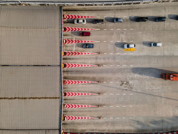 An aerial top down view of a toll booth with vehicles