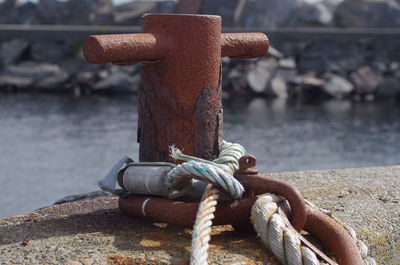 Close-up of rope tied up on metal chain