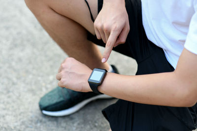 Midsection of man using mobile phone