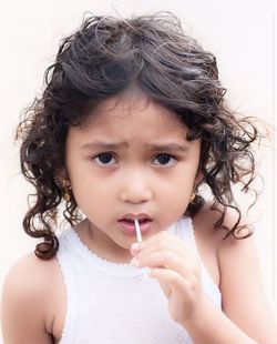 Portrait of cute girl holding camera