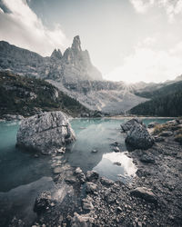 Scenic view of lake and mountains against sky