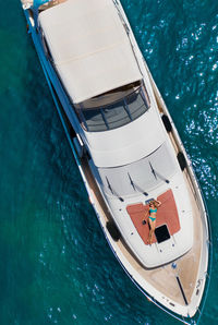 Woman lying on boat deck on sea