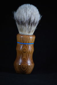 Close-up of candle against black background