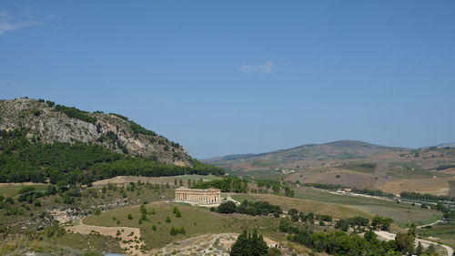 Scenic view of mountains against blue sky