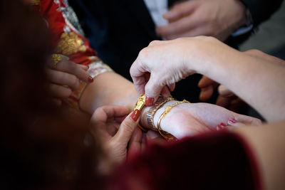 Close-up of hands during wedding ceremony