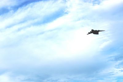 Low angle view of silhouette airplane flying in sky