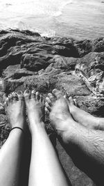 Low section of woman relaxing in water