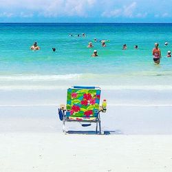 People sitting on chair at beach