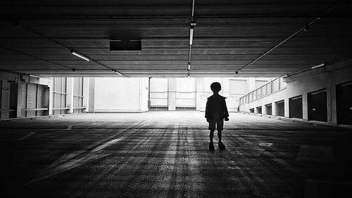 Boy standing in parking garage
