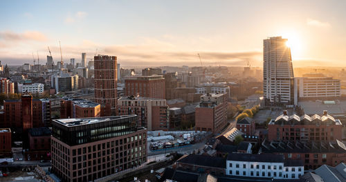 An aerial panoramic view of a leeds cityscape skyline at sunrise