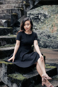 Young woman sitting on rock